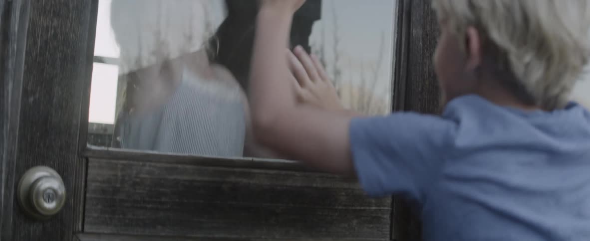 Children jump up and down hitting a window