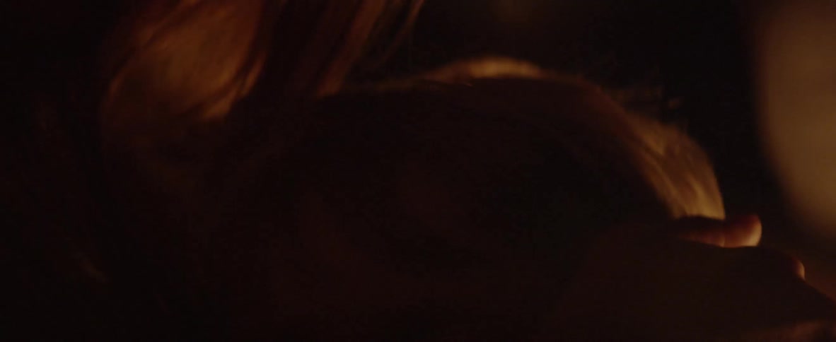 A woman kisses and brushes the hair of her child
