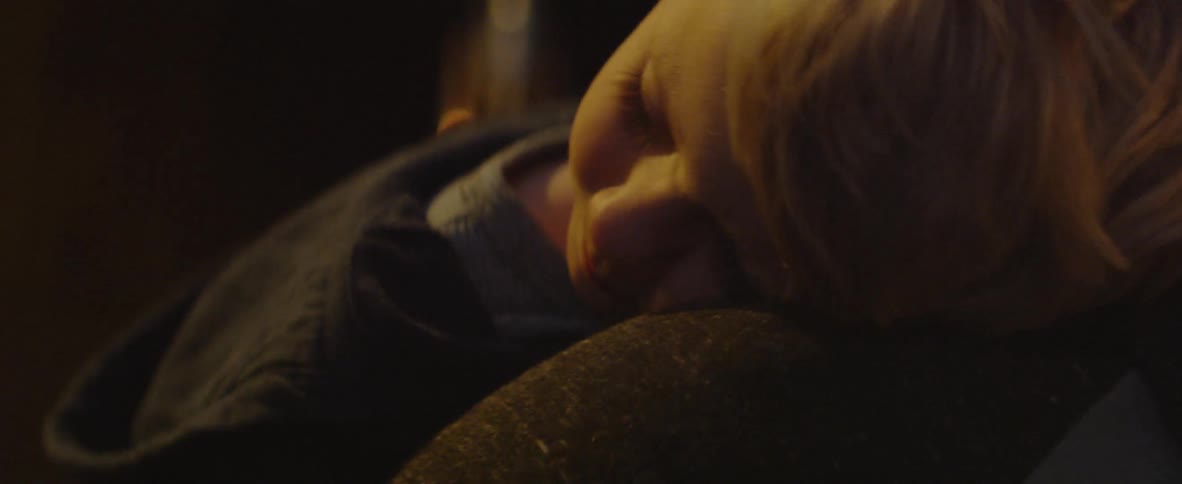 A dad carries his sleeping son