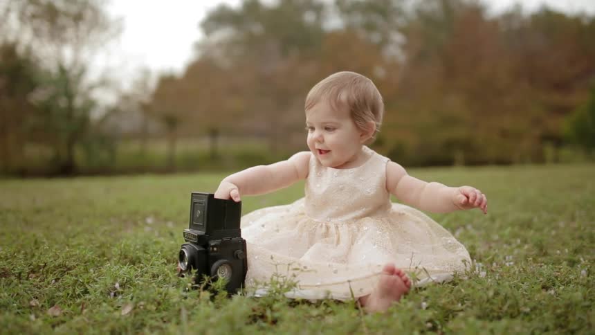 A child is playing with a camera