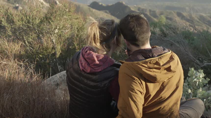 A couple is looking at their phone