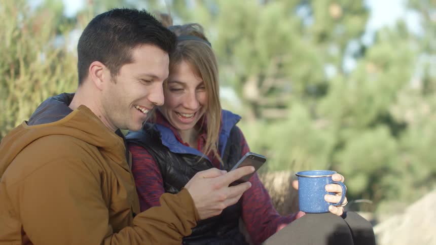Couple In Mountains With Cell Phone