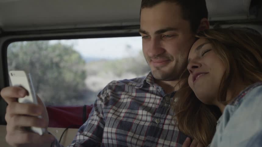 A couple is riding in the car