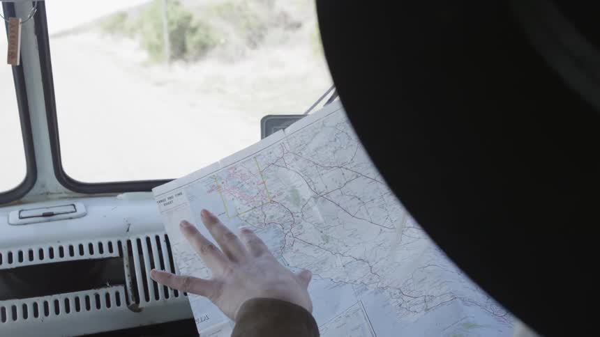 Person reading a map inside of a vehicle