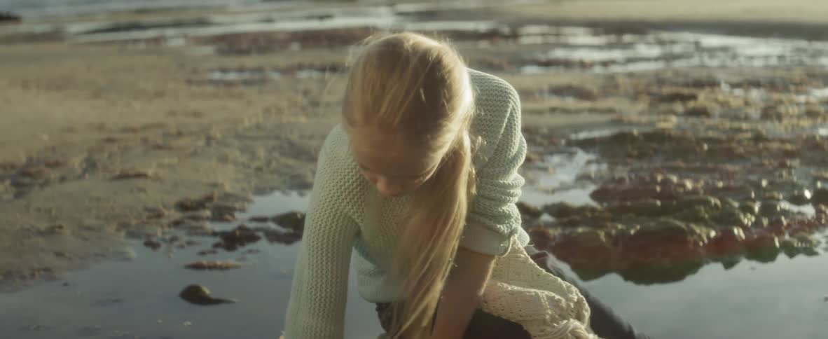 A child is playing at the beach outdoors in spring