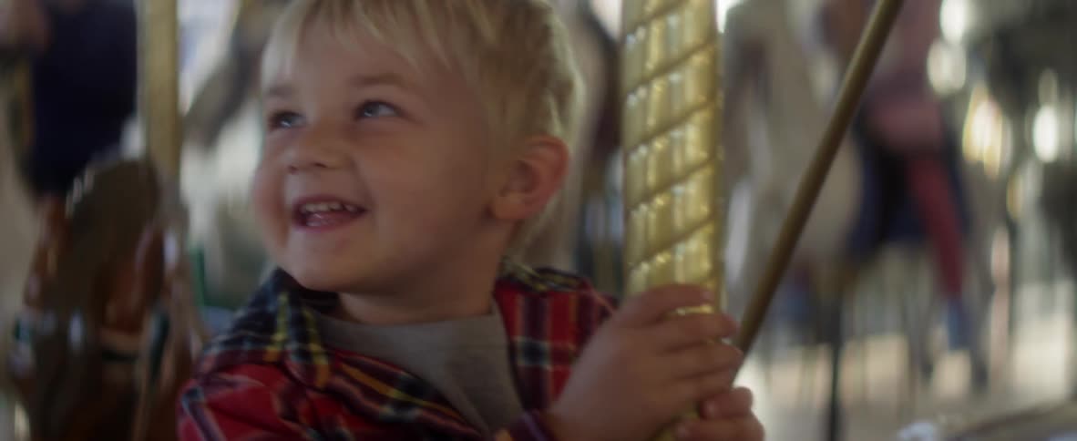 A child rides a carousel