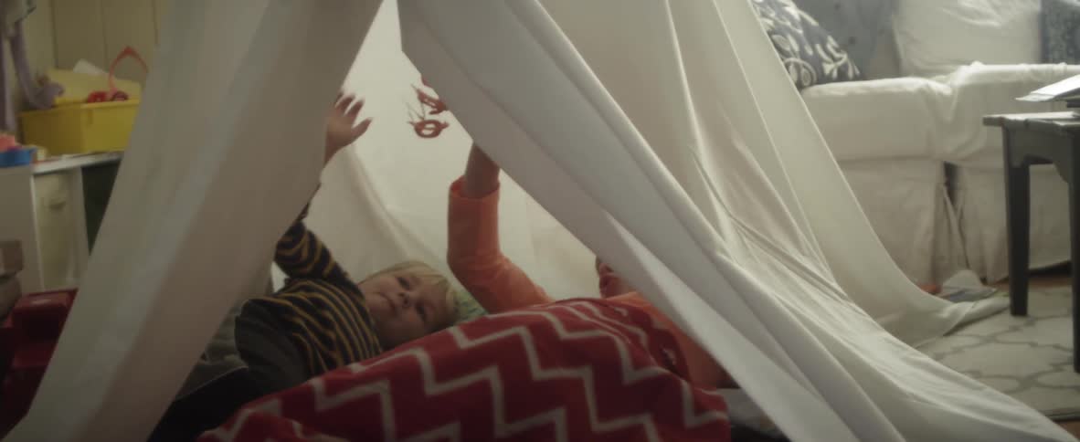 A child is playing in a tent