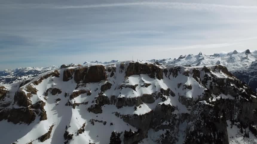 The mountains are covered with many snow slopes