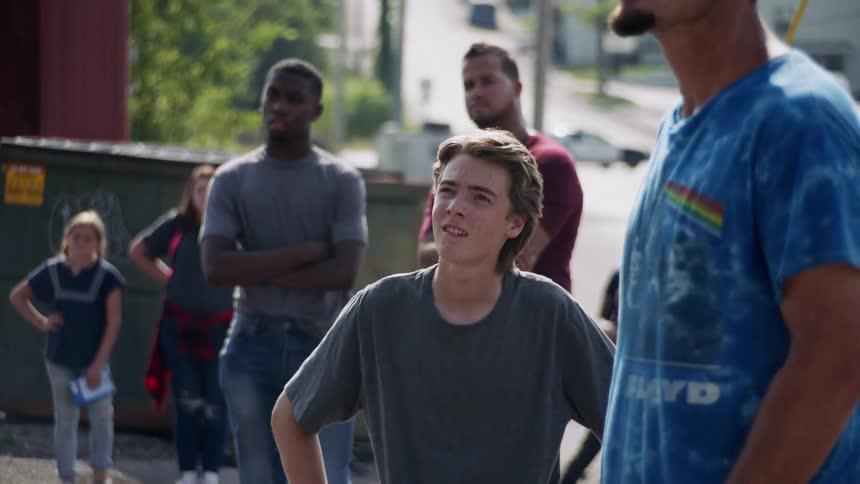 People stand in the lot together looking at something
