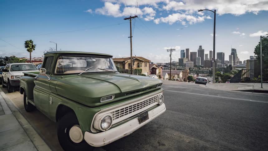 Cars drive on a city street