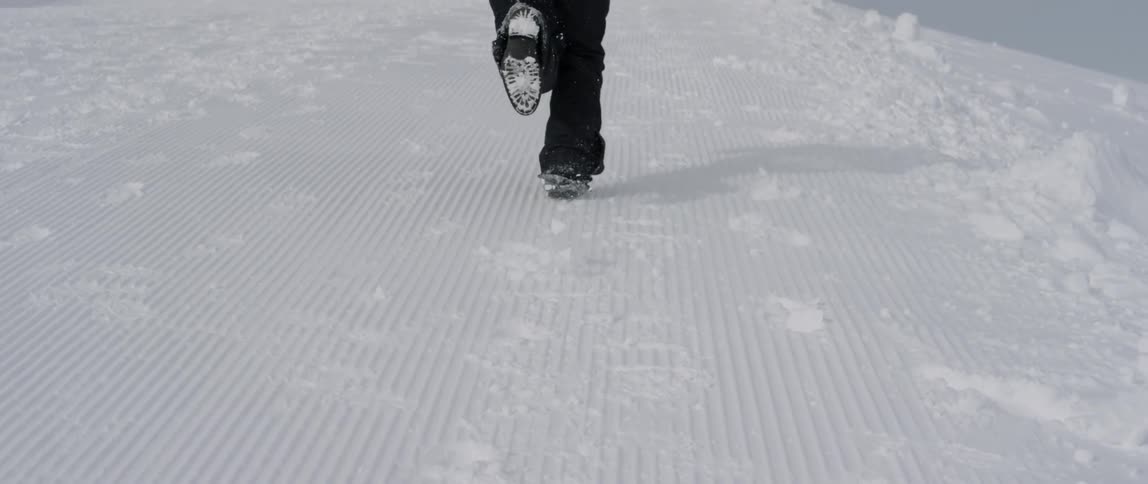 A man races in the snow uphill