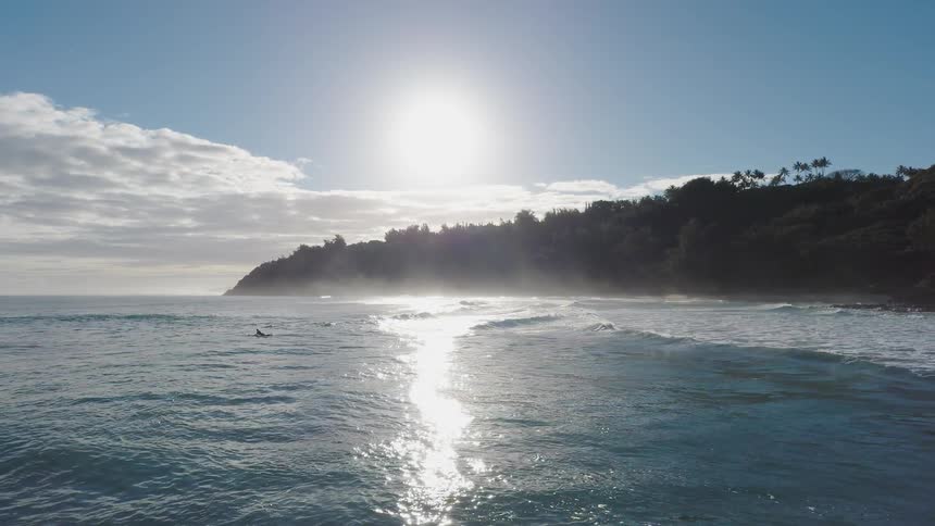 The water near the shore is rough with many waves