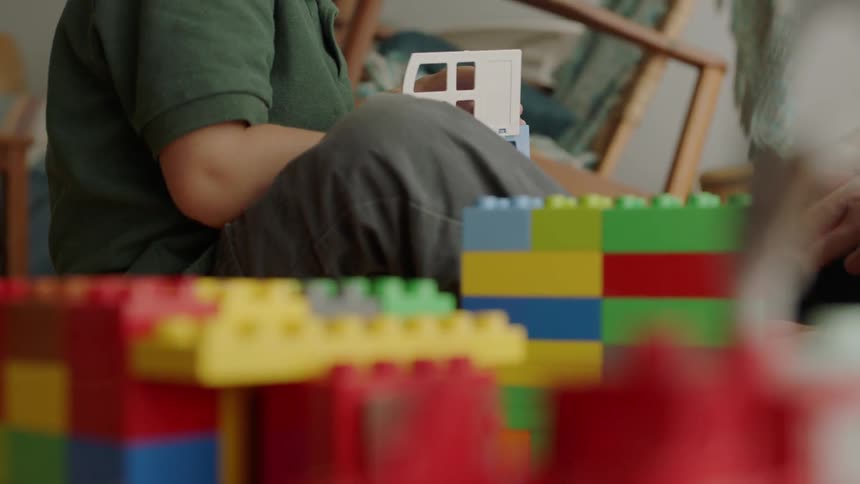 Young boy plays with colored blocks