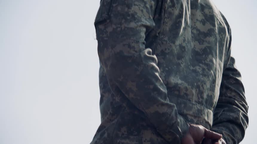 The soldier is standing at ease