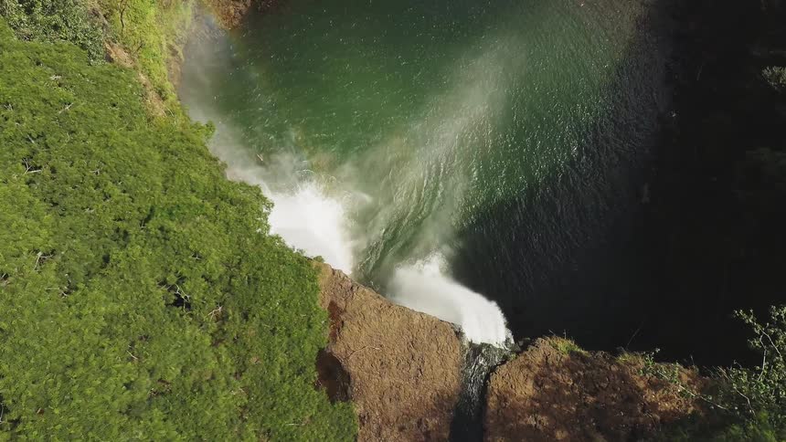 A waterfall flows over a cliff