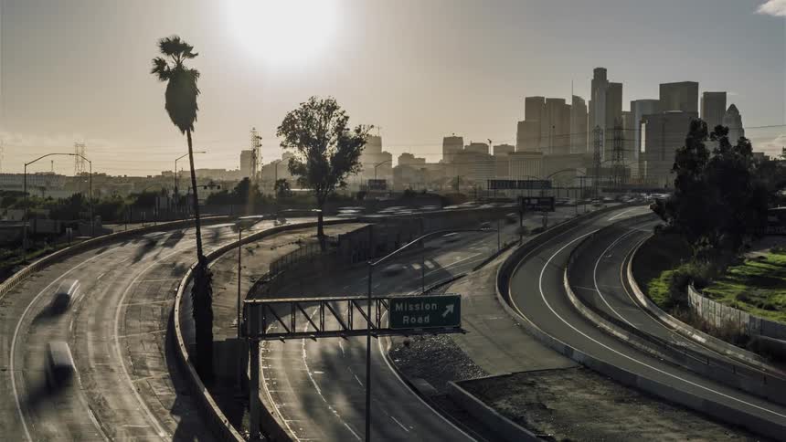 Cars drive on a city street