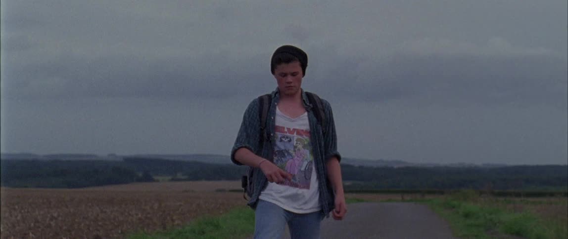 A young man skateboards on the road