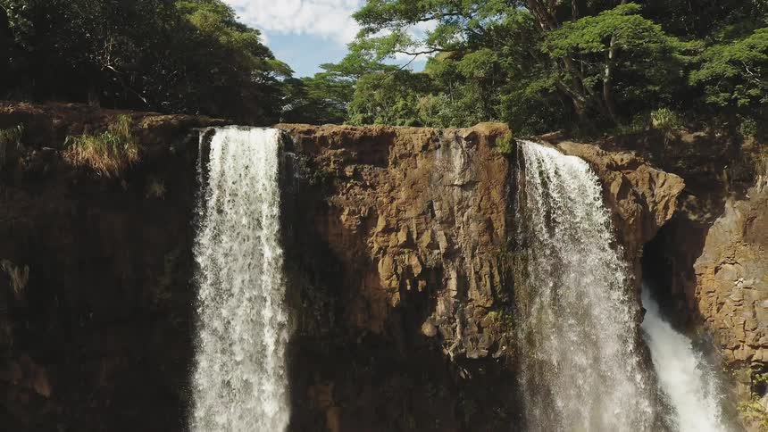 Waterfalls flow over a cliff