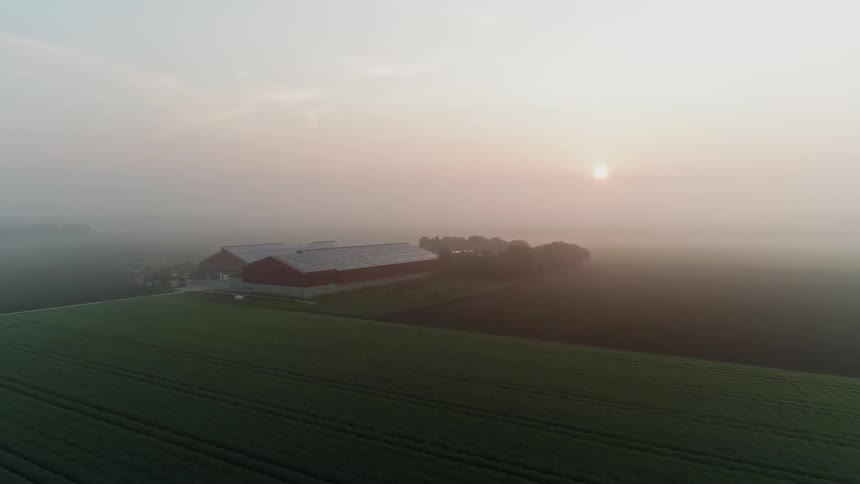 The sun shines on a large farm