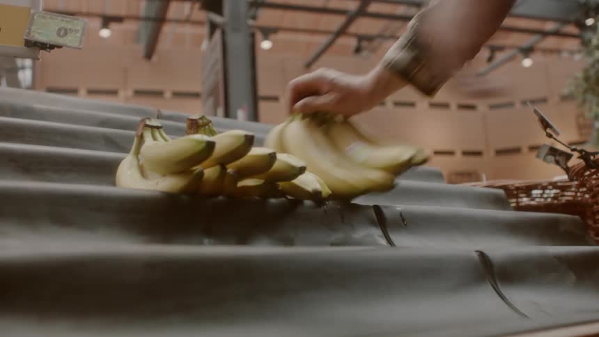 Bananas are being stacked on the stand