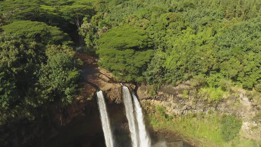 Waterfalls flow over a cliff