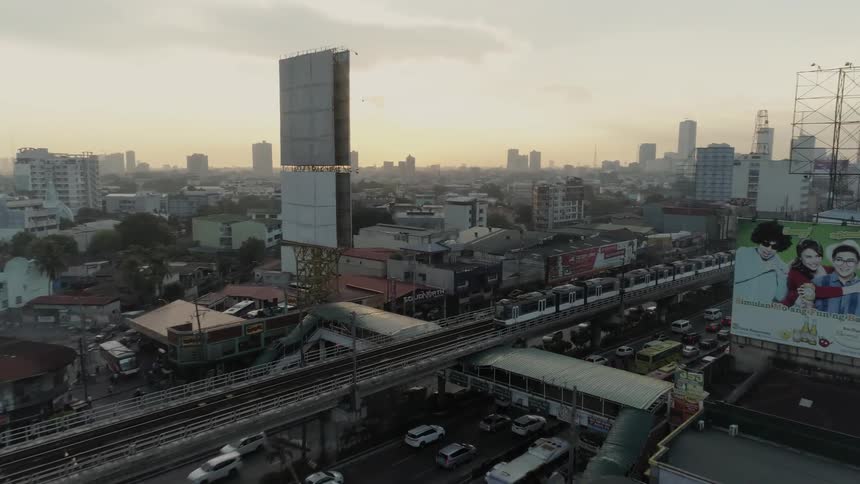 The train travels through the city over the road