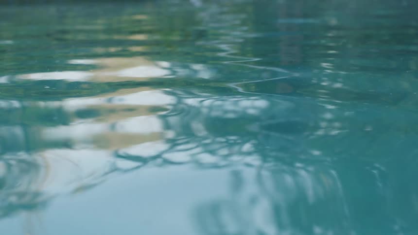 The pool water moves slowly back and forth