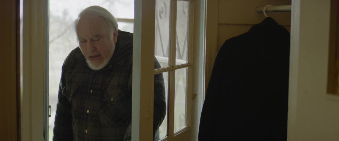 A man walks over and opens the door before exiting again