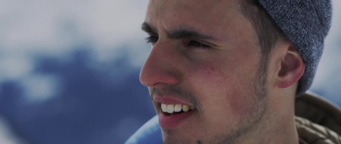 A man looks around outside in the cold