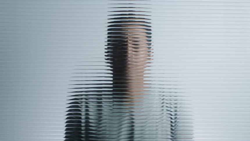 Looking at a man through blurry glass
