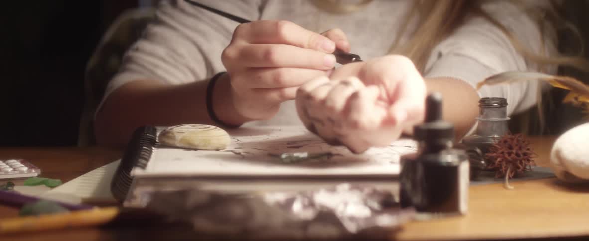 A girl draws on herself with ink