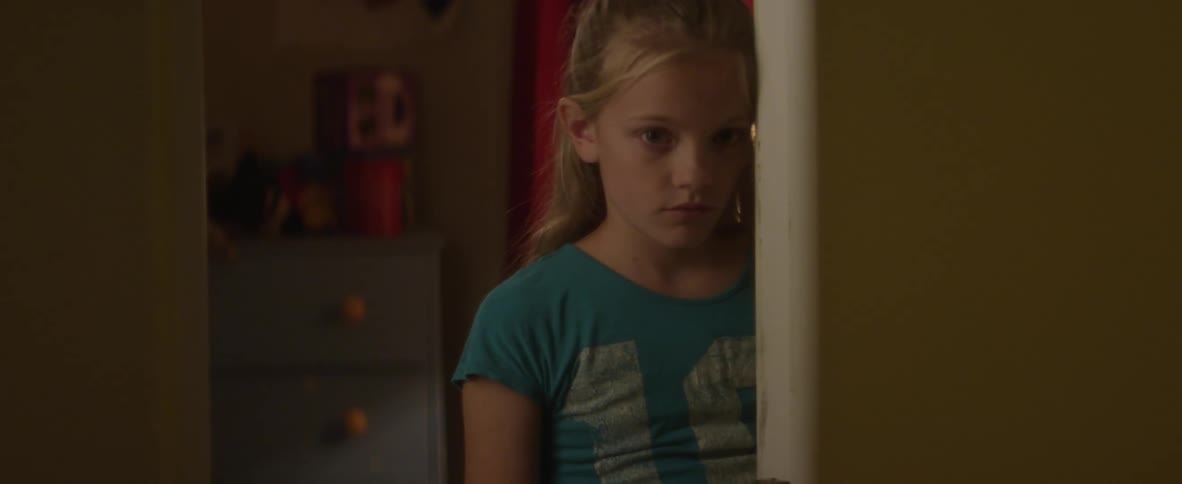 A child peeks through the doorway