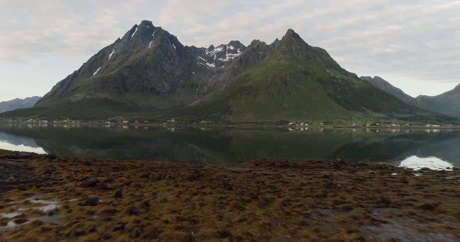 The lake leads to a mountain range ahead