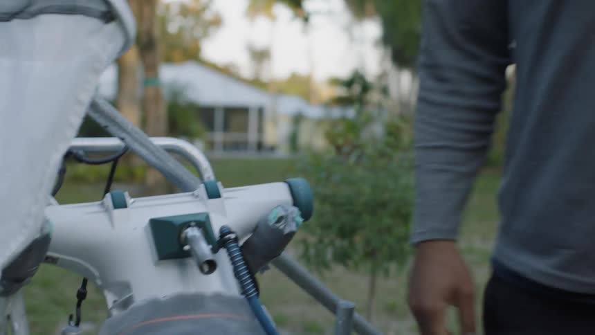 Person pulls a machine and sets a net on top