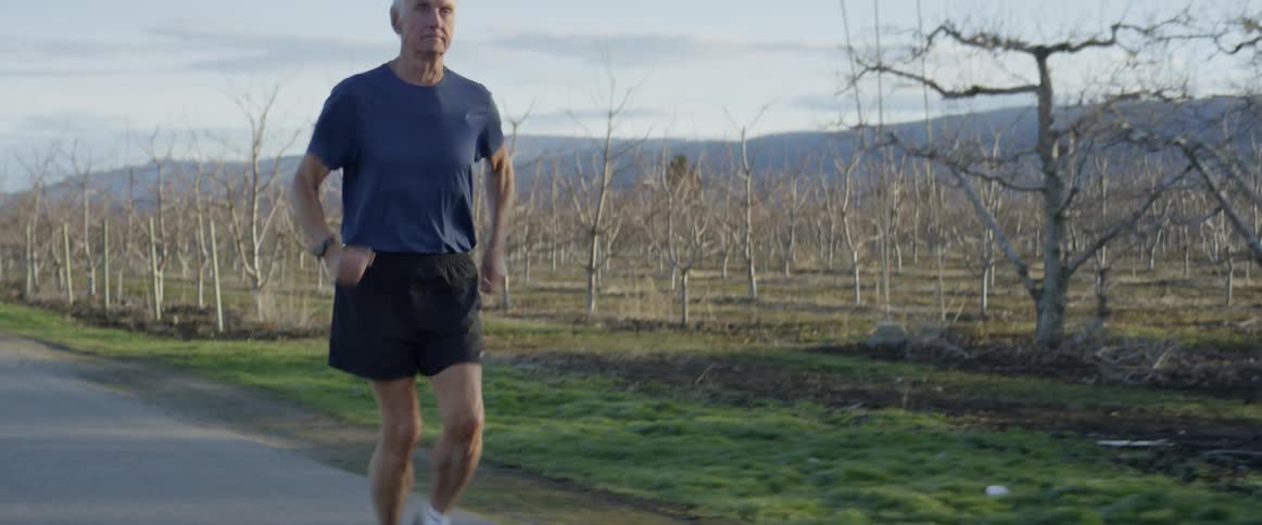 A man jogs on a rural road