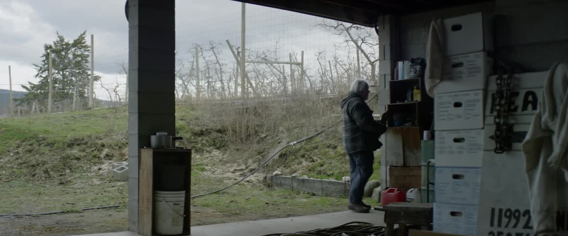 A man packs some items away in his garage