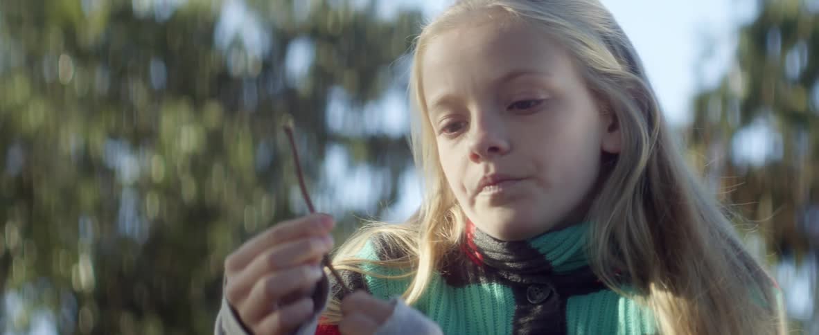 A girl holding a twig