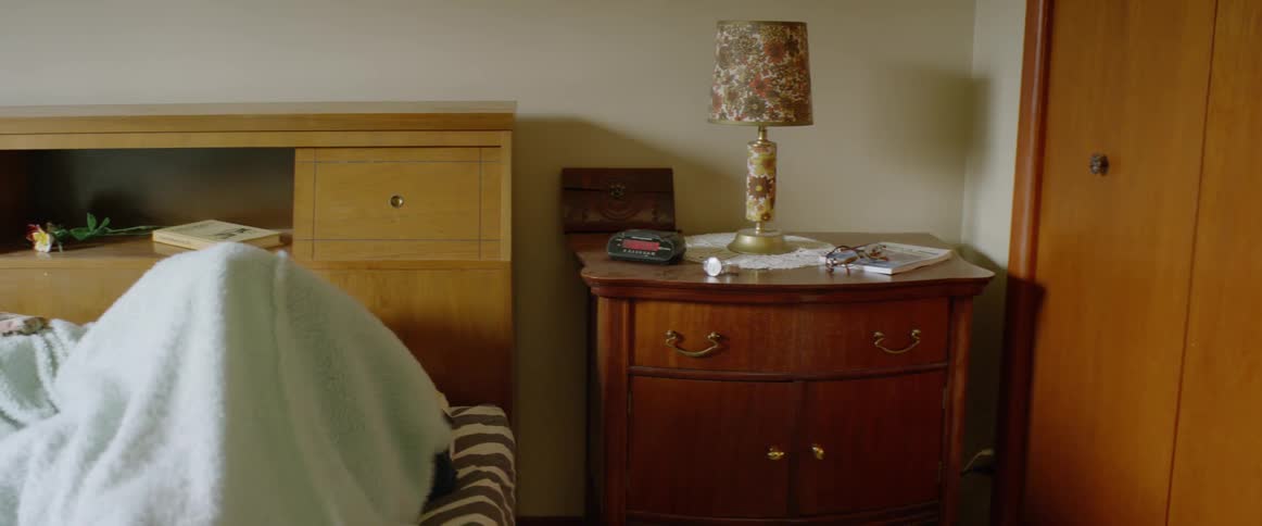 A man slowly gets up out of bed