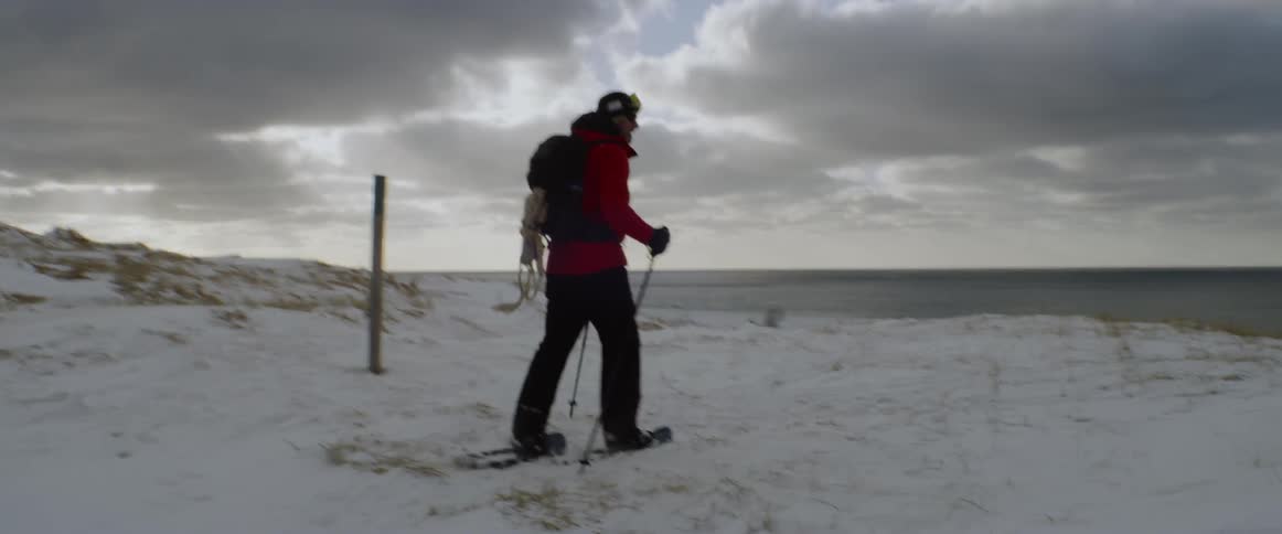 A man snowshoes in the wilderness