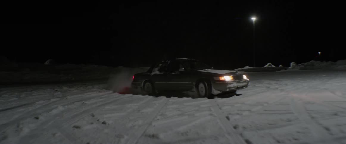 A car drives and spins out on a snow covered road