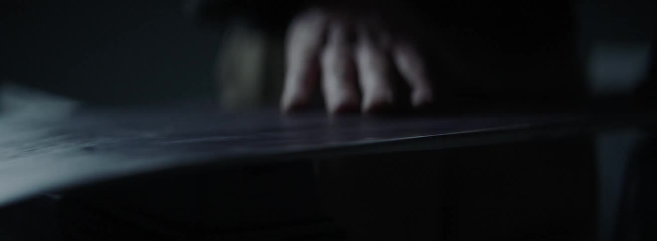A man runs his hand over a smooth plank