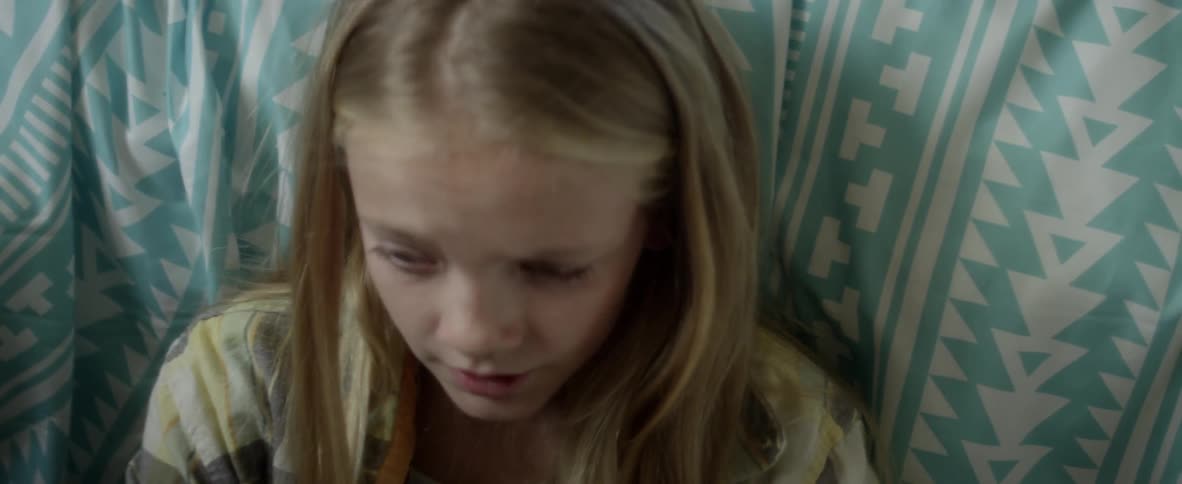 A child sits worried on the floor
