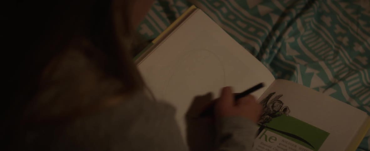 Person drawing in a notebook