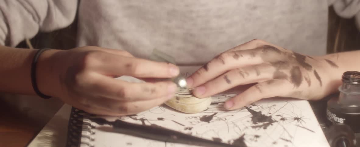 Man carving into a small stone