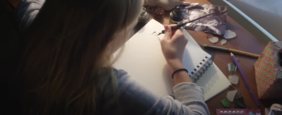 A girl begins to write a letter