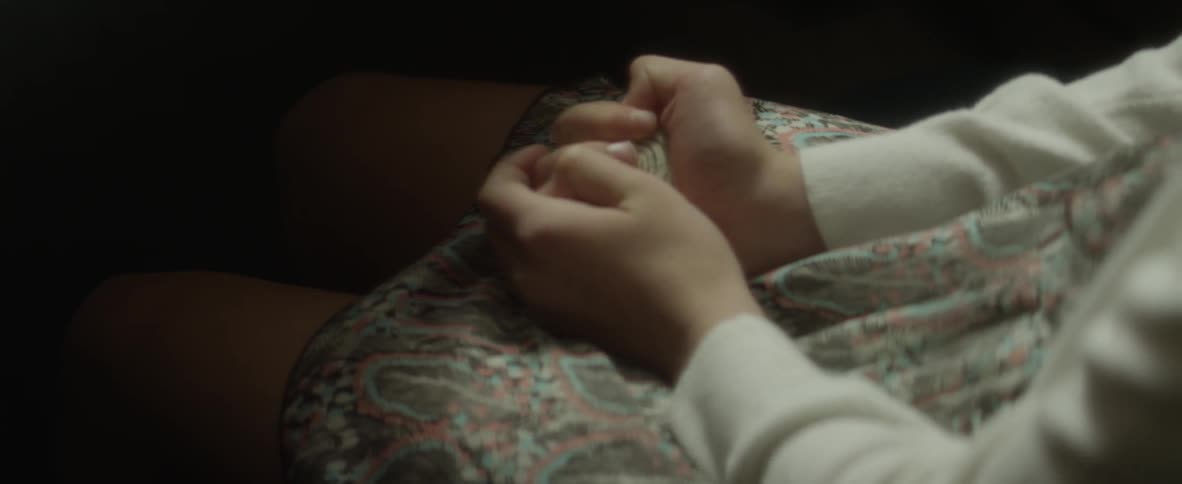 A woman is clutching her dress