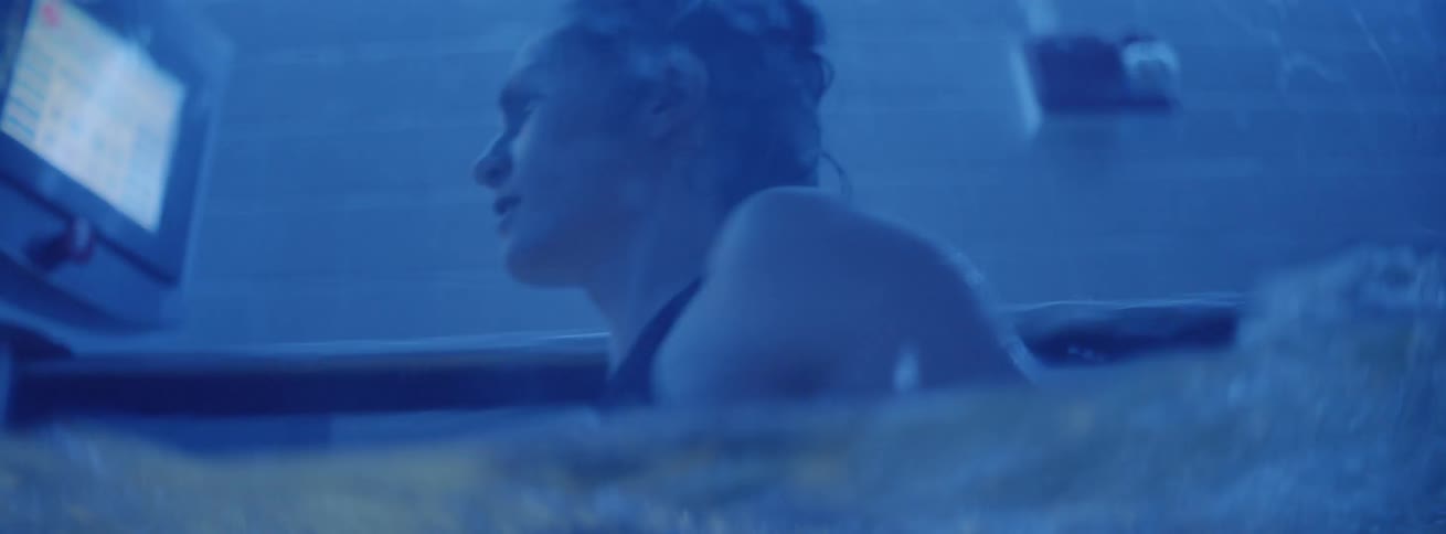 Woman runs on an underwater treadmill