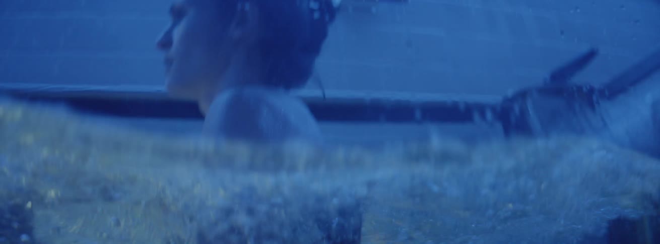 A woman runs on the treadmill in the water