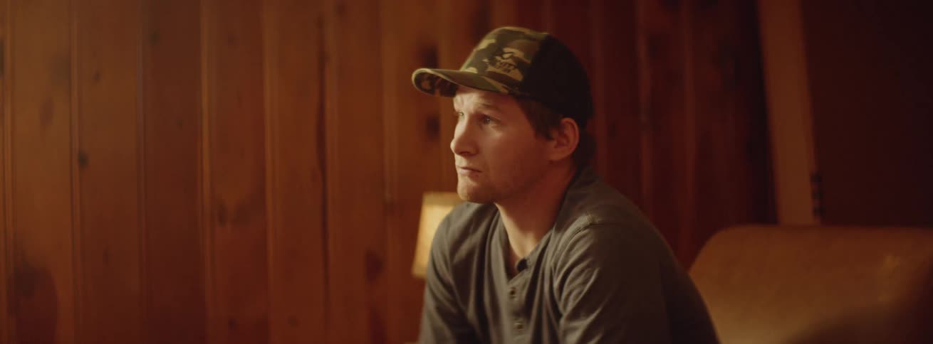 A man sits in the room looking forward