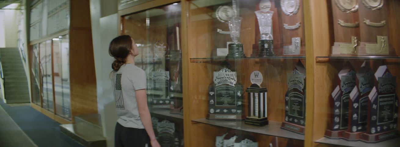 A girl checks out the trophies in the display case